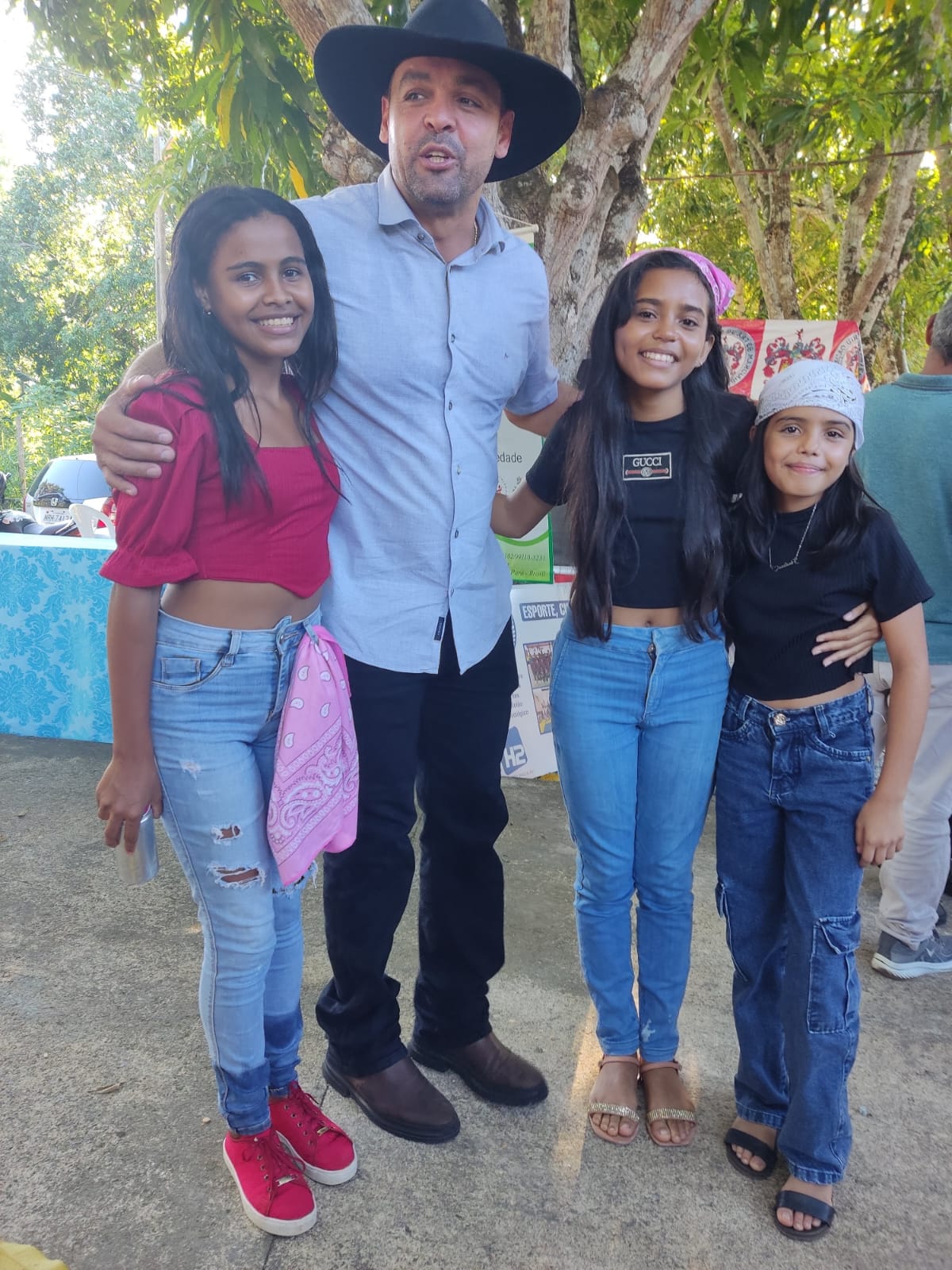 Três jovens e um adulto reunidos em registro fotográfico durante a 15ª Conferência Municipal de Assistência Social